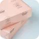 Kotak karton pink berlapis matte, tersusun di atas latar terang.